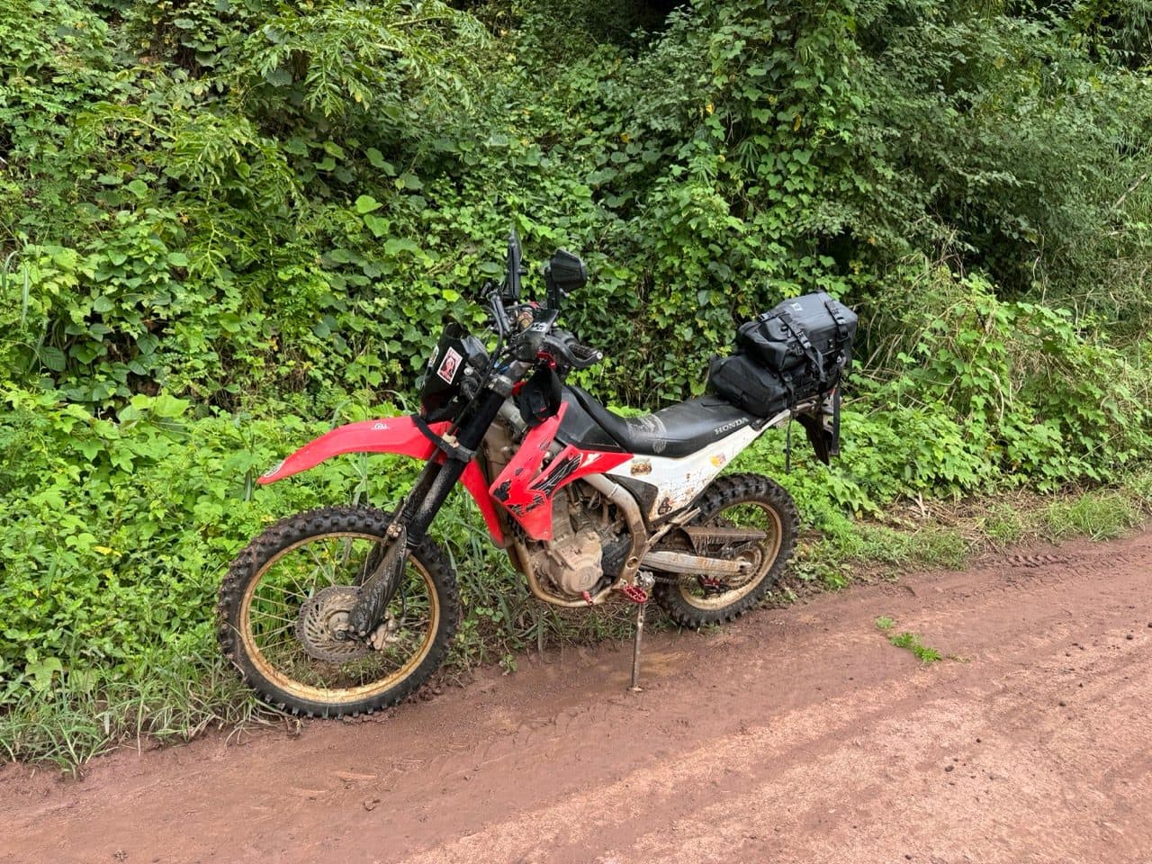 The CRF250L on the verge, already carrying some of the trail