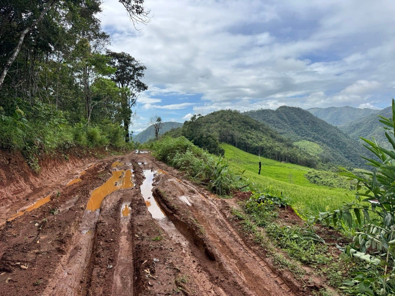 Deep ruts holding standing orange water.