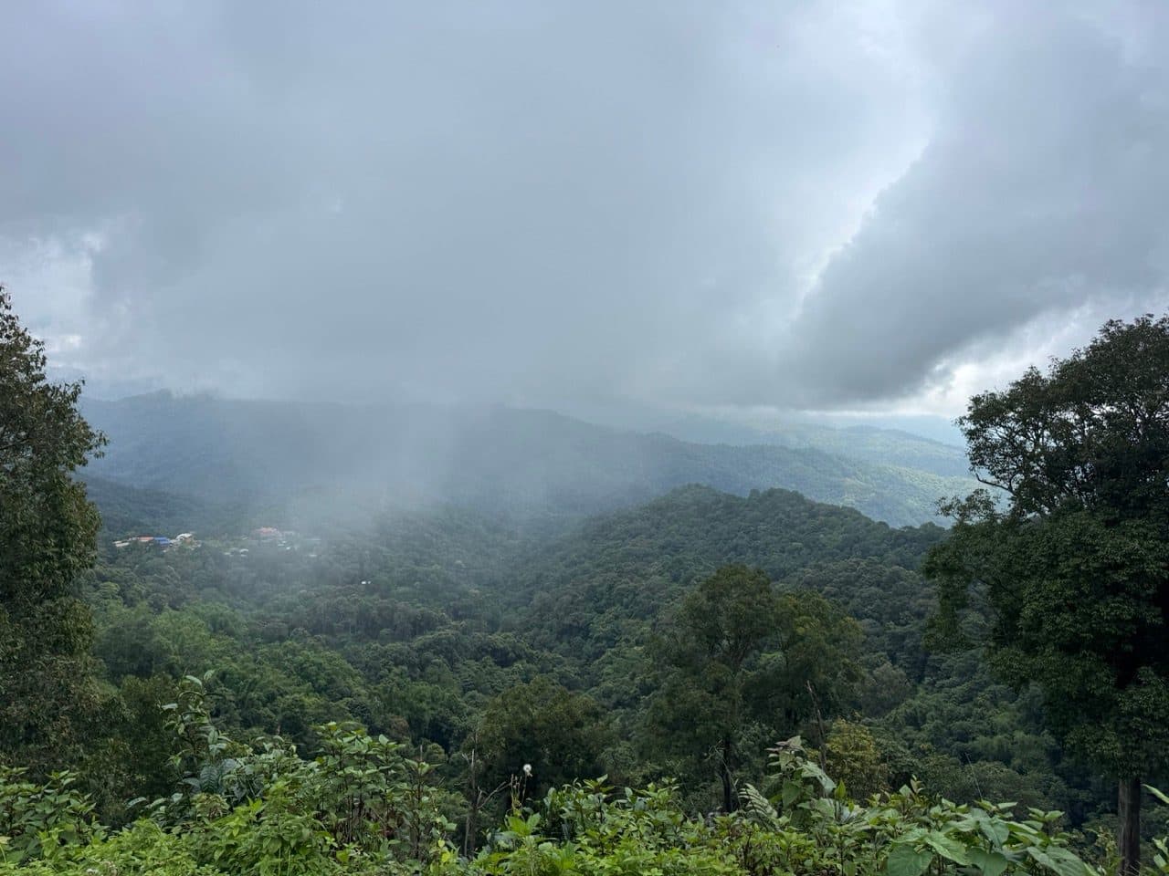 Rain sheeting across the valley below the ridge