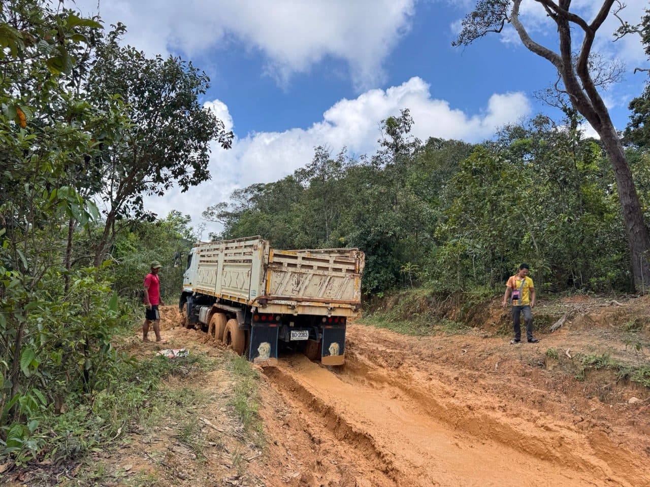 A tipper parked in the churn, and the crew standing around it.